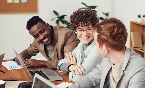 Photo Of People Leaning On Wooden Table 3182754 (1) (1)